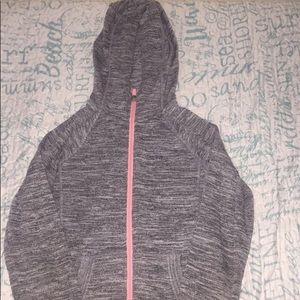 A grey sweater with a pink zipper; size M